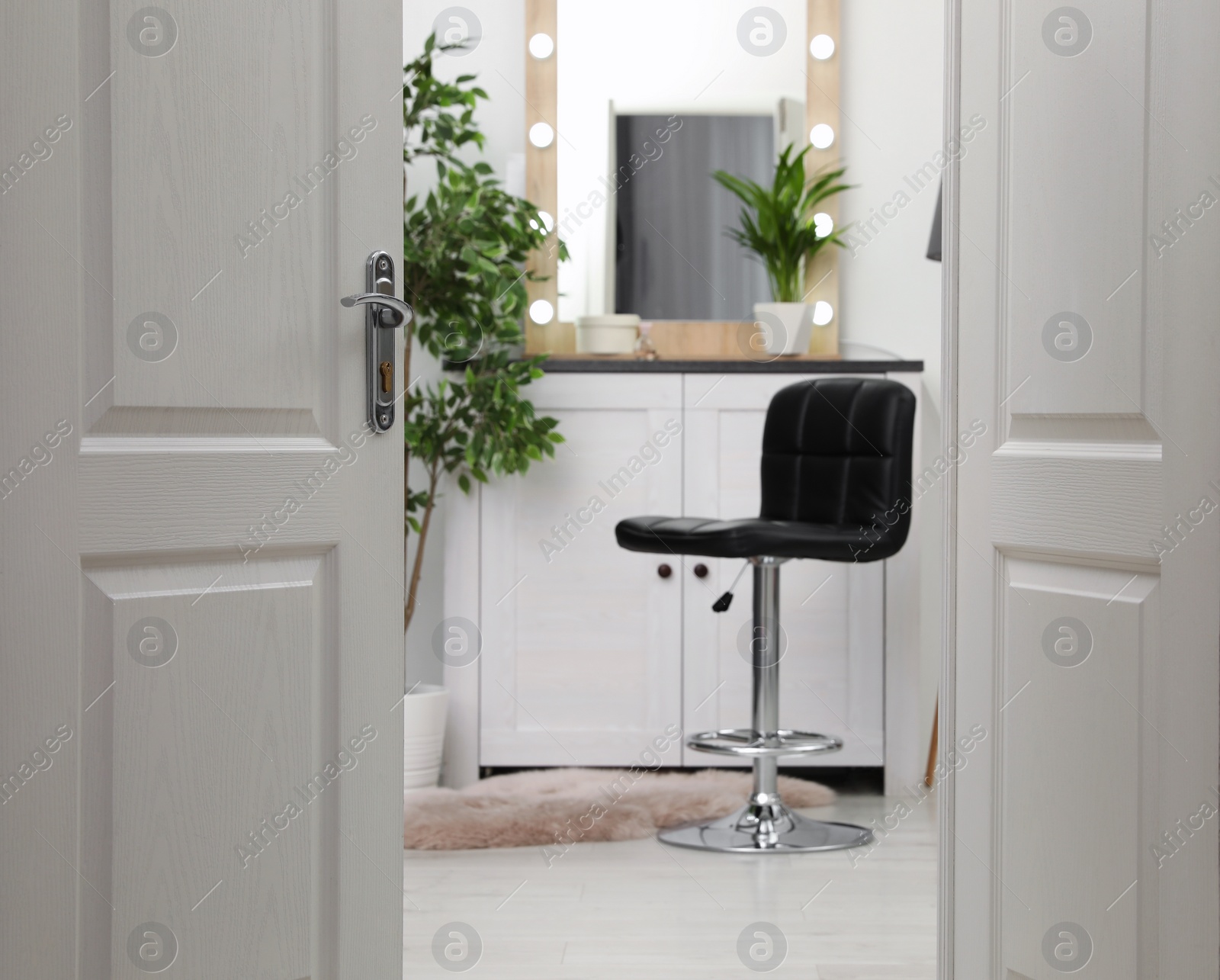 Photo of Stylish room interior, view through open door