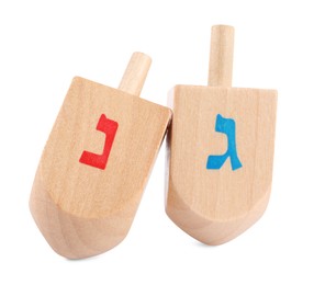 Hanukkah celebration. Wooden dreidels with jewish letters isolated on white