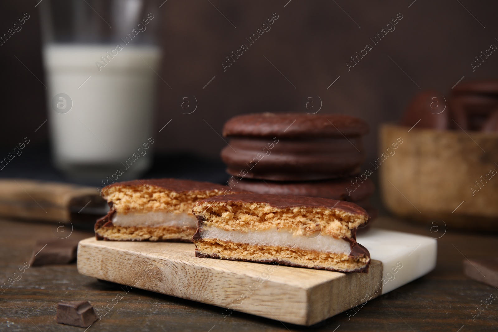 Photo of Tasty choco pies on wooden table, closeup. Space for text