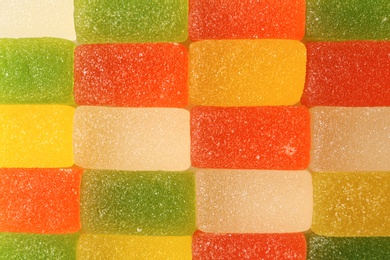 Delicious color jelly candies as background, top view