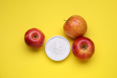 Photo of Sweet powdered fructose and apples on yellow background, flat lay
