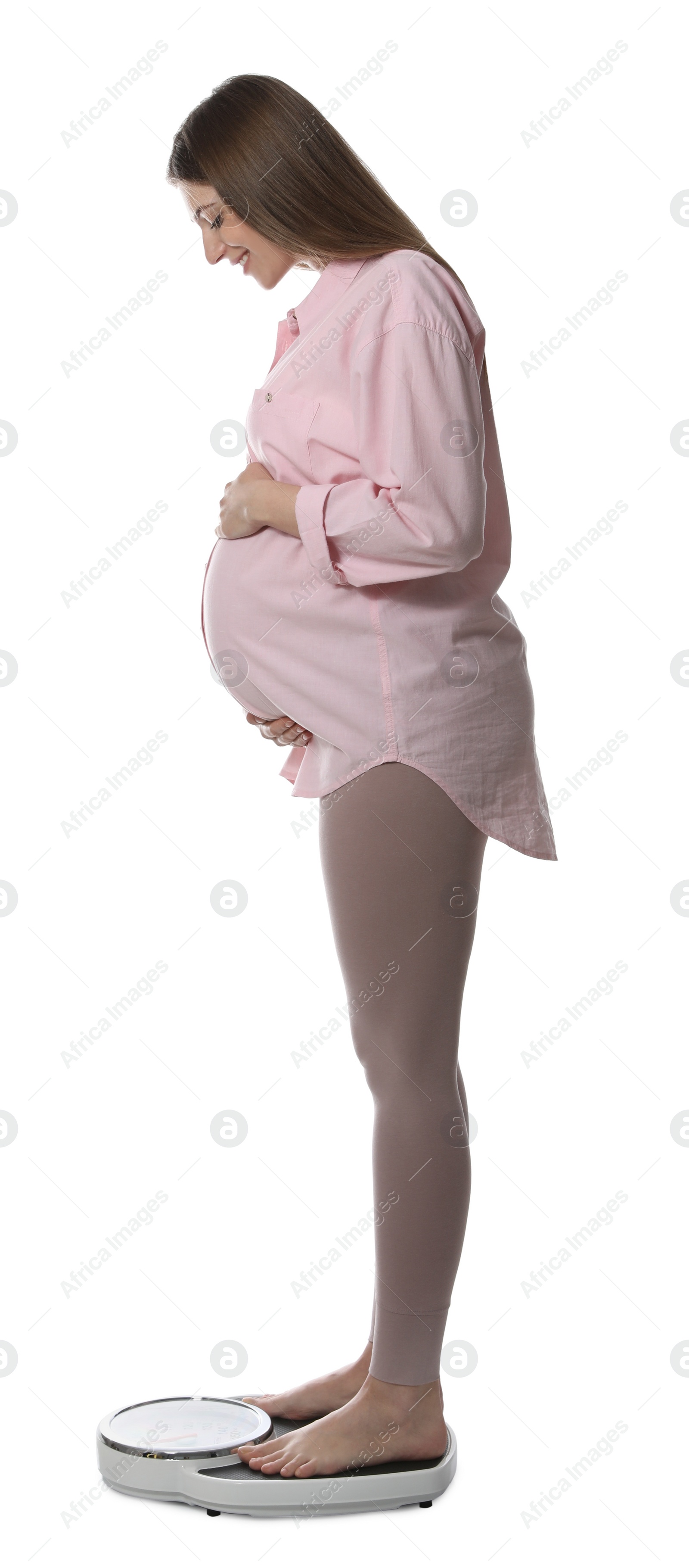 Photo of Pregnant woman standing on scales against white background