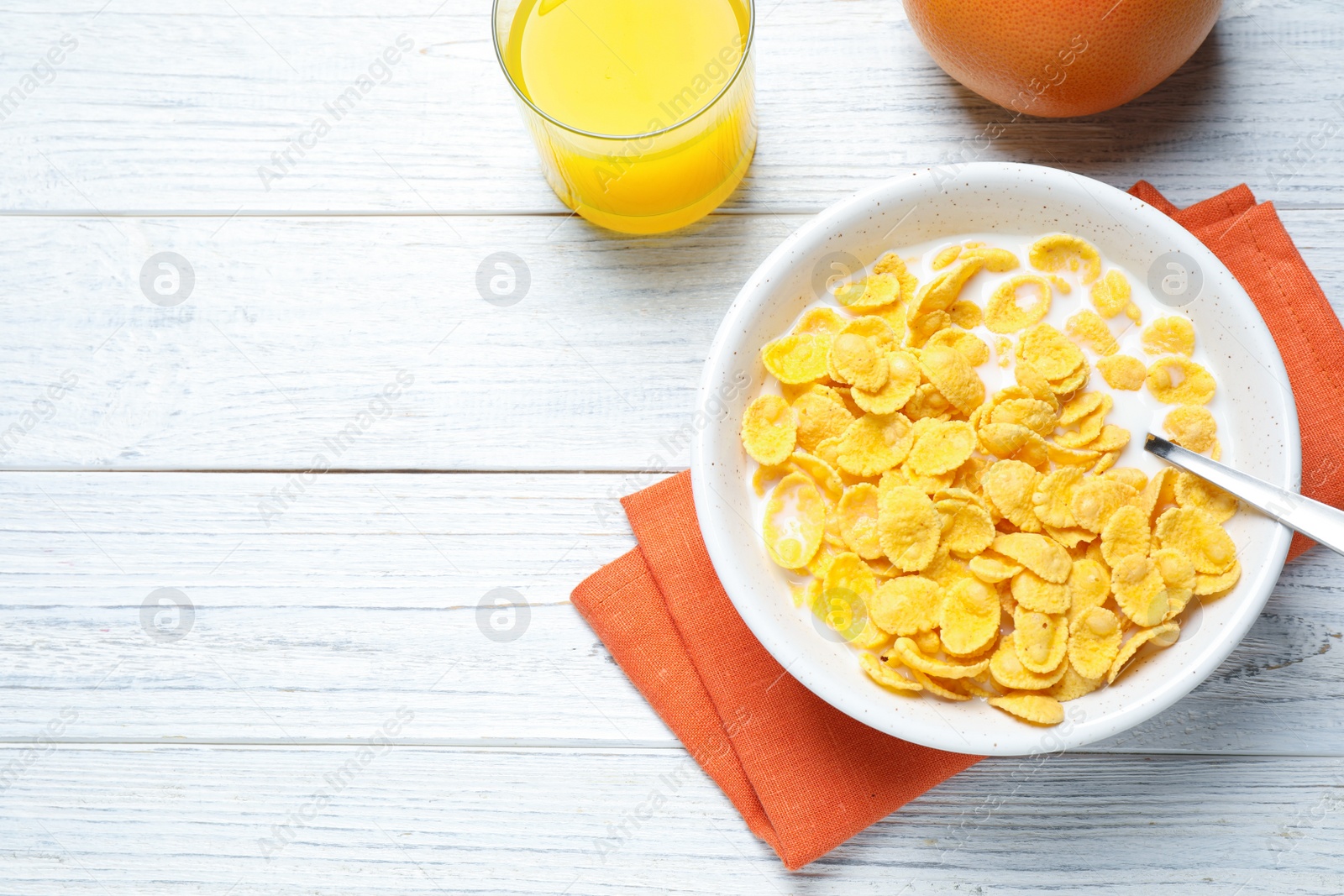 Photo of Flat lay composition with tasty corn flakes on white wooden table. Space for text