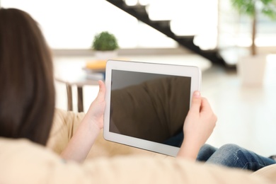 Photo of Cute girl using video chat on tablet at home, space for text