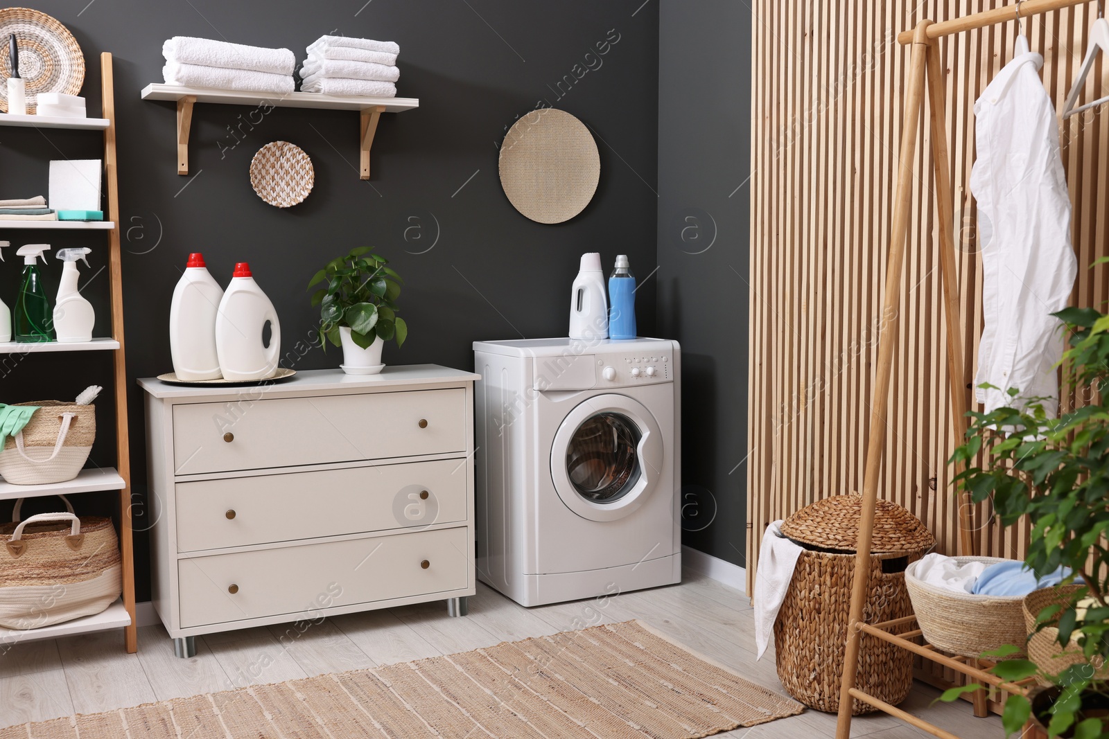 Photo of Laundry room interior with washing machine and furniture