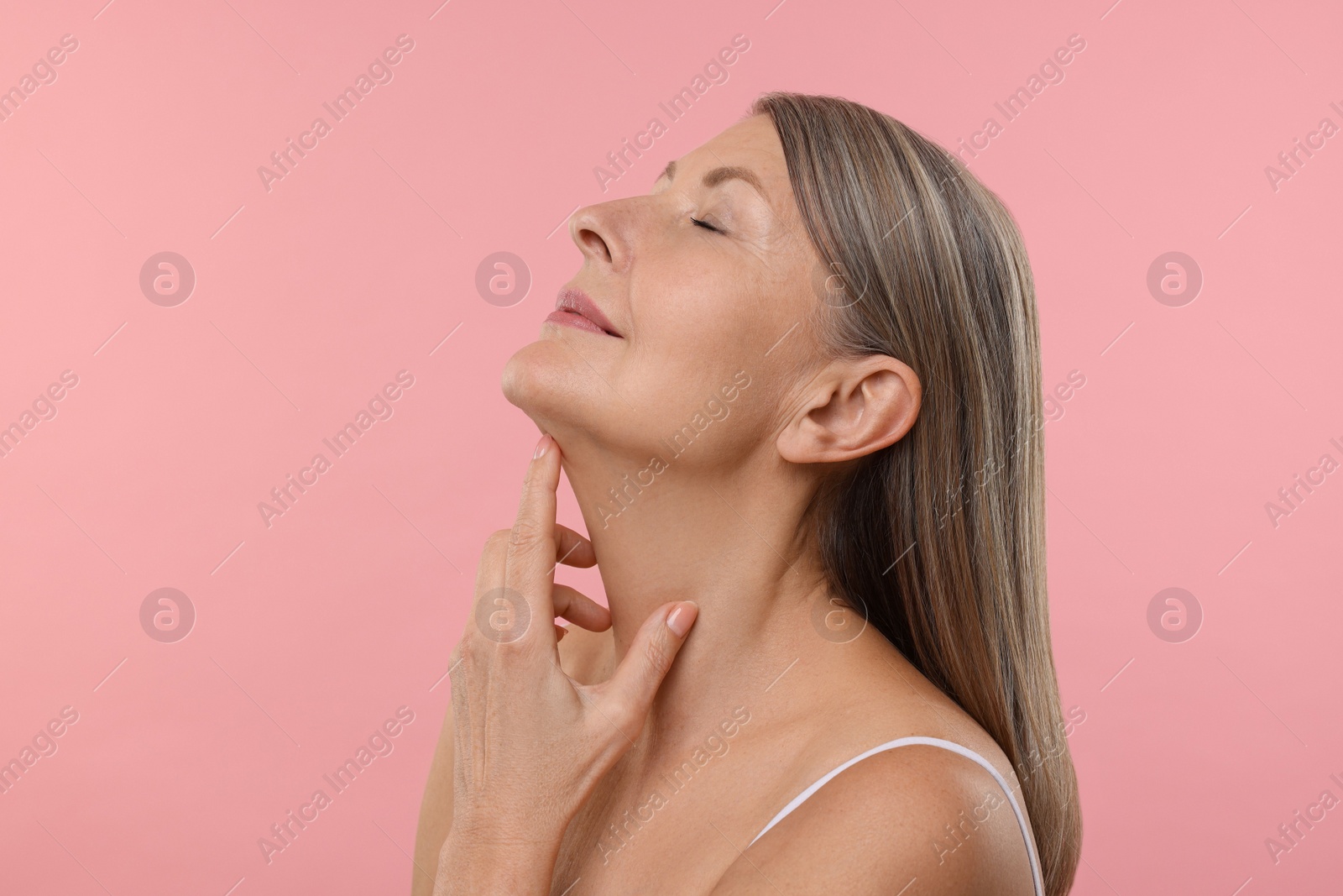 Photo of Beautiful woman with healthy skin on pink background