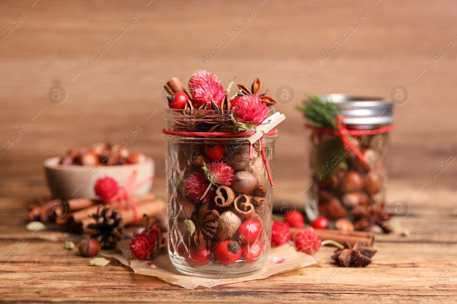 Photo of Aromatic potpourri in glass jar on wooden table
