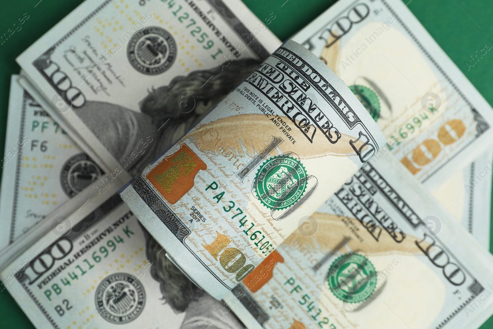 Photo of Money exchange. Dollar banknotes on table, top view