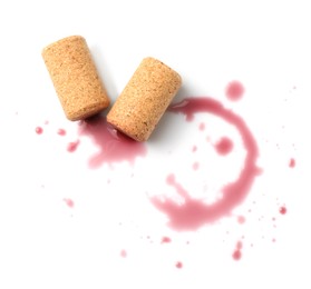 Photo of Bottle corks with wine stains on white background, top view