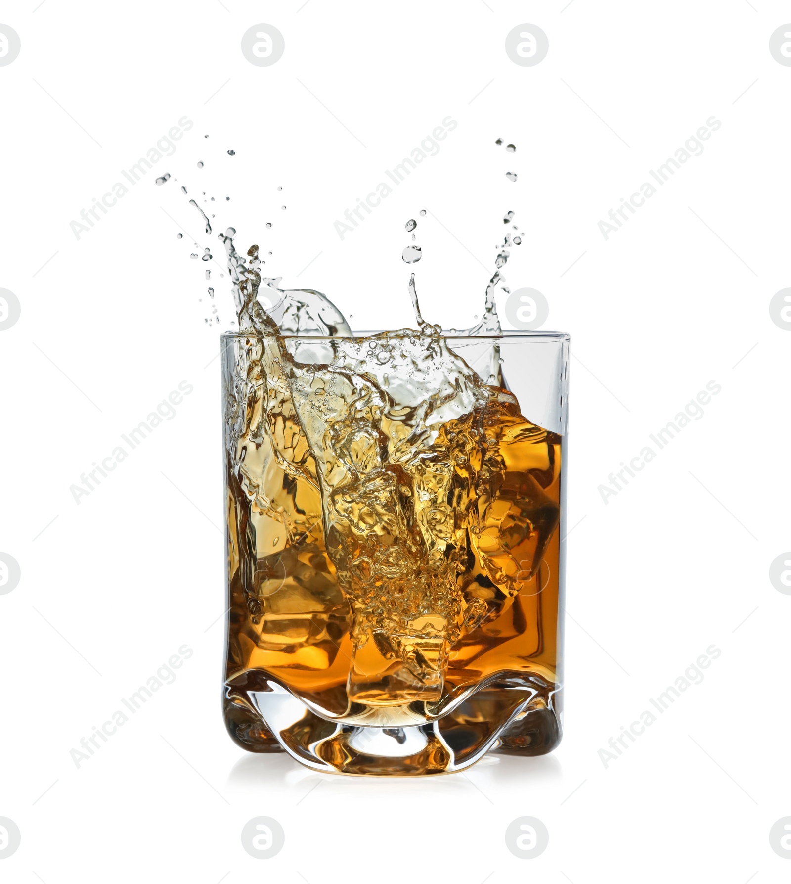 Photo of Whiskey splashing out of glass on white background