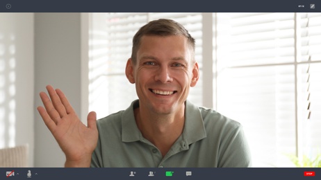 Image of Man communicating with coworkers from home using video chat, view through camera