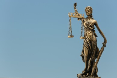 Figure of Lady Justice against sky, space for text. Symbol of fair treatment under law