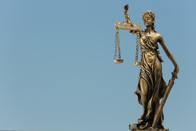 Photo of Figure of Lady Justice against sky, space for text. Symbol of fair treatment under law