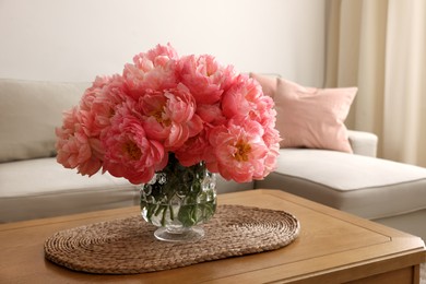 Photo of Beautiful pink peonies in vase on table at home, space for text. Interior design