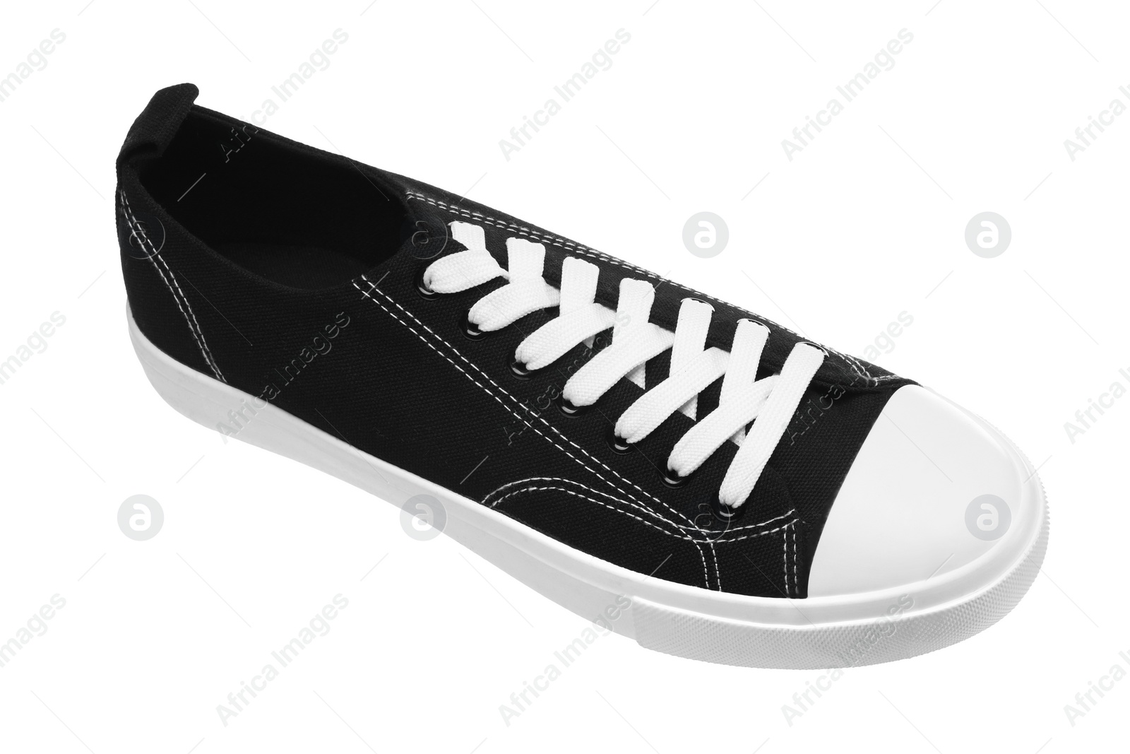 Photo of One black classic old school sneaker isolated on white