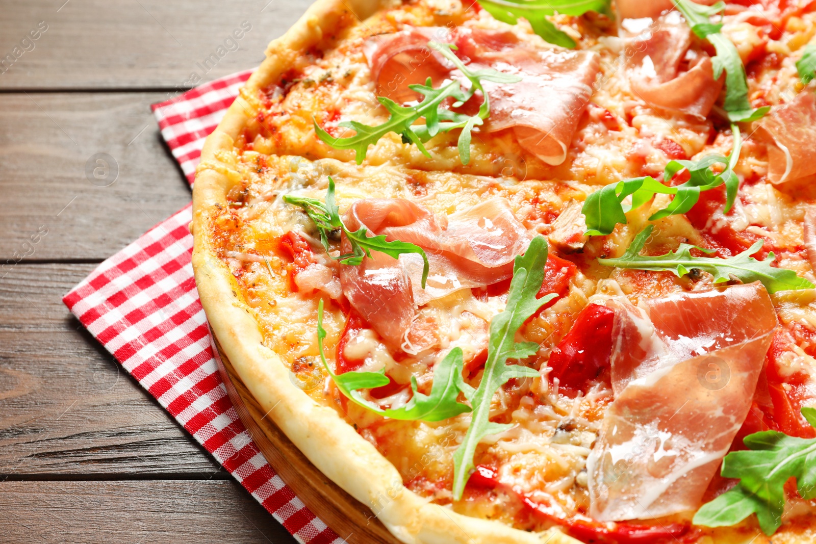 Photo of Tasty hot pizza with meat on wooden background