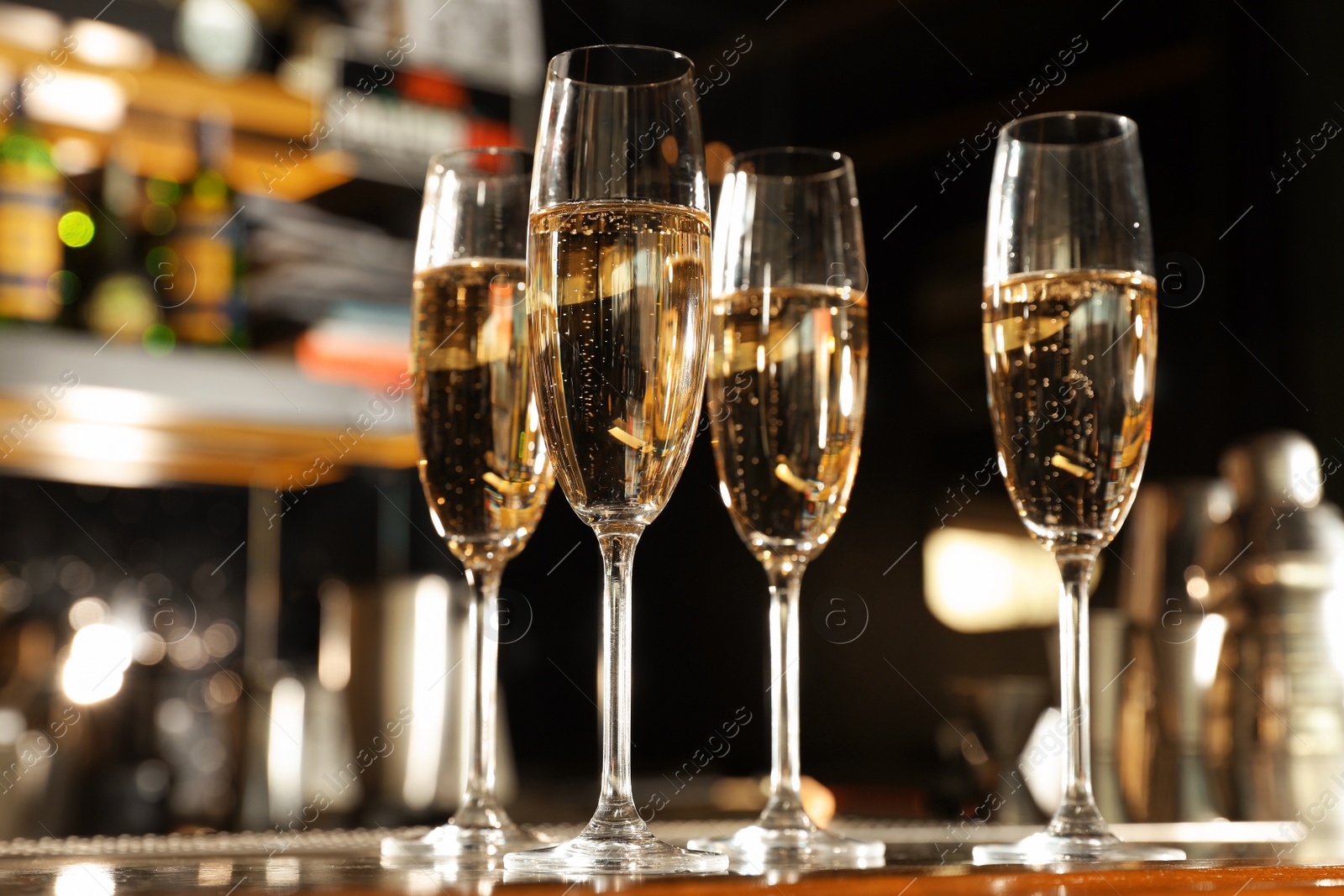 Photo of Glasses of champagne on counter in bar