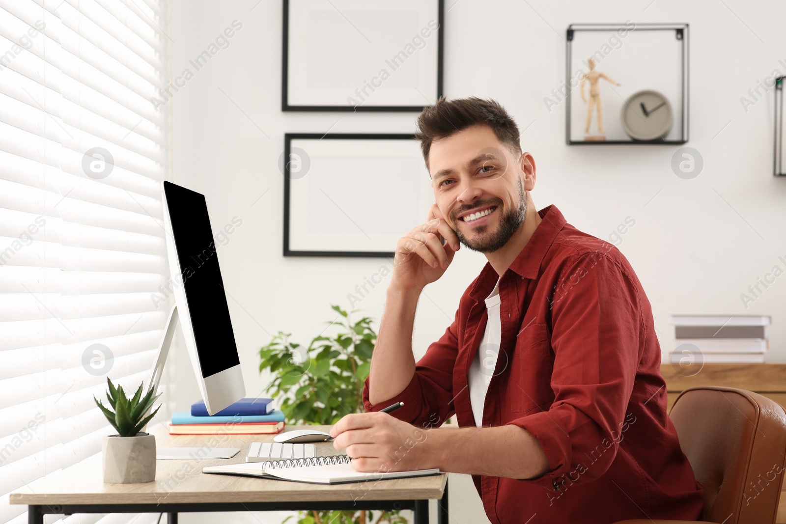 Photo of Portrait of man studying near computer at home. Online translation course