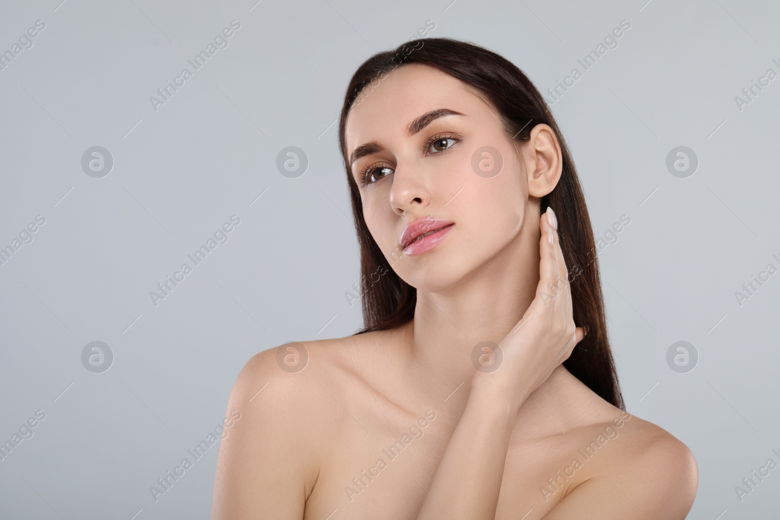 Photo of Portrait of beautiful young woman on light grey background