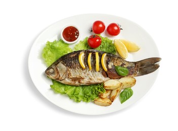 Photo of Tasty homemade roasted crucian carp with garnish on white background, top view. River fish