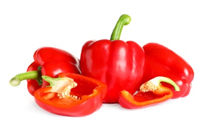 Photo of Cut and whole ripe red bell peppers on white background