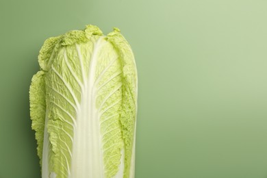 Photo of Fresh ripe Chinese cabbage on pale green background, top view. Space for text