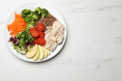 Photo of Balanced diet and healthy foods. Plate with different delicious products on white marble table, top view. Space for text