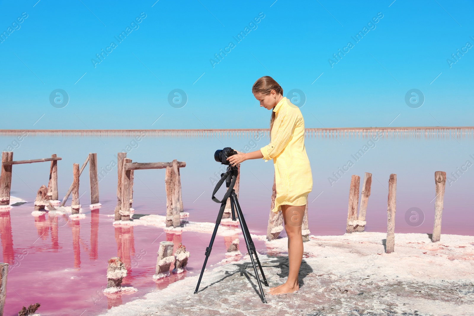 Photo of Professional photographer taking photo of pink lake on sunny day