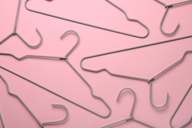 Photo of Many hangers on pink background, flat lay