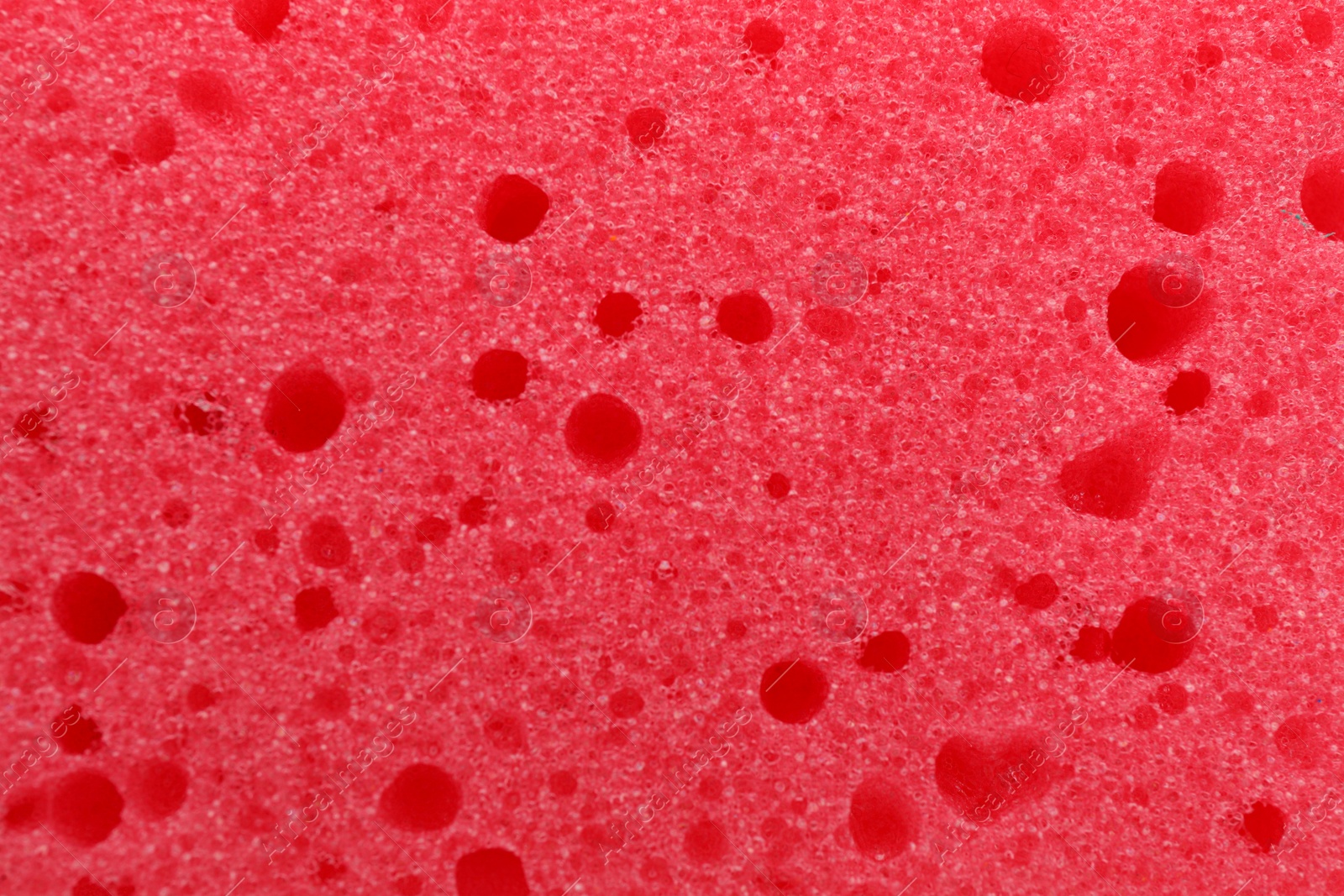 Photo of Red cleaning sponge as background, top view