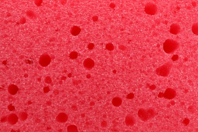 Photo of Red cleaning sponge as background, top view
