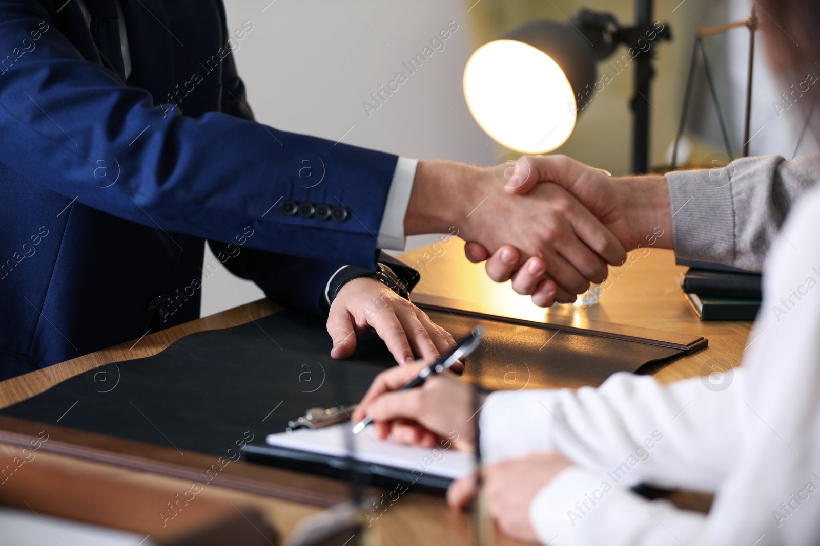 Photo of Male lawyer working with clients in office, closeup