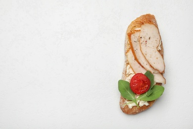 Photo of Delicious chicken bruschetta on white table, top view. Space for text