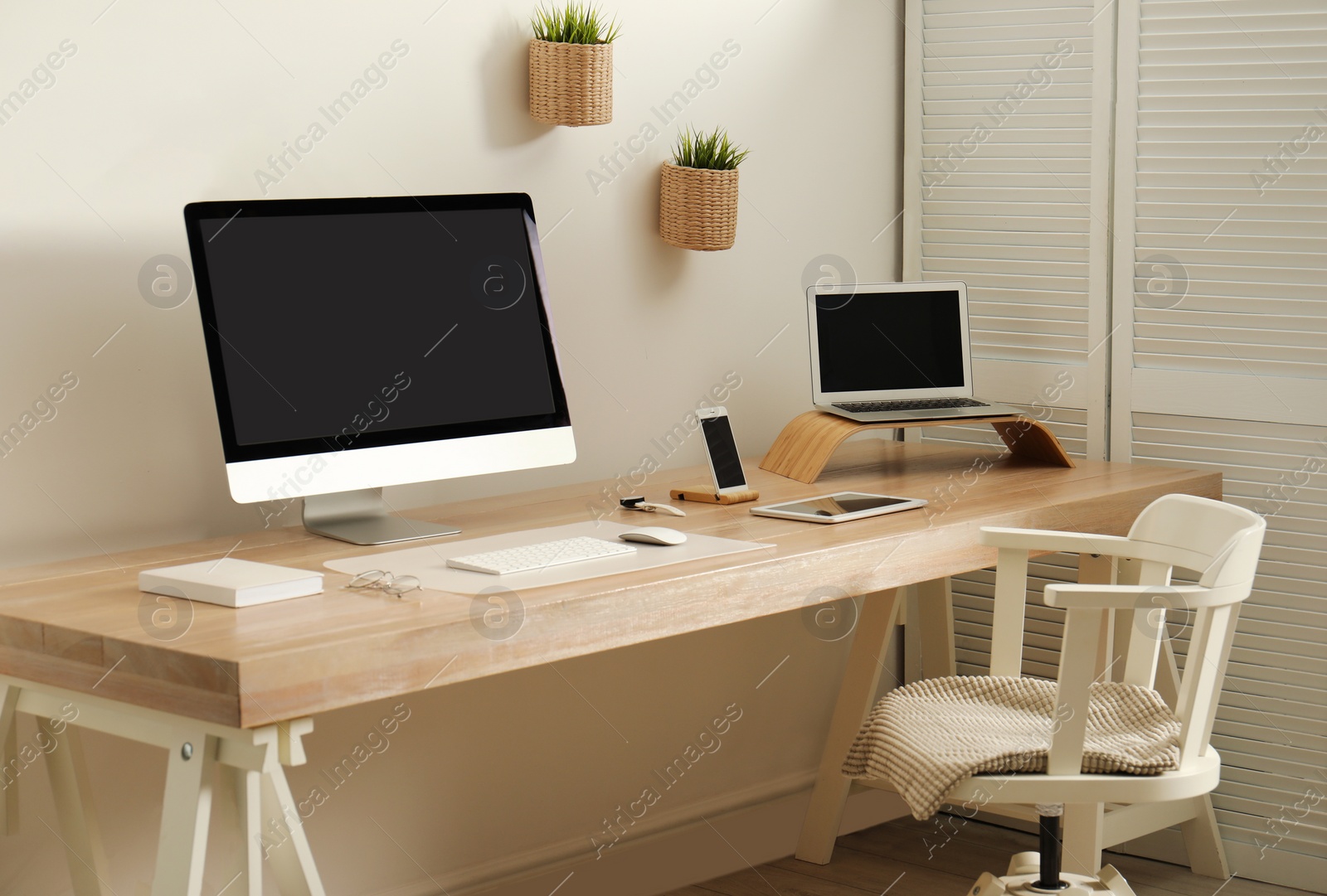 Photo of Stylish workplace interior with modern computer on table. Mockup for design