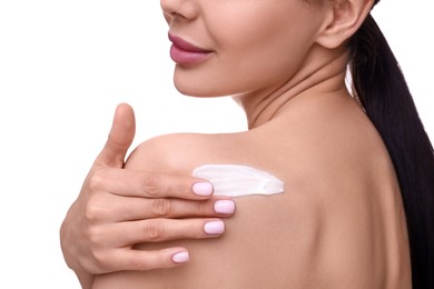 Woman with smear of body cream on her shoulder against white background, closeup