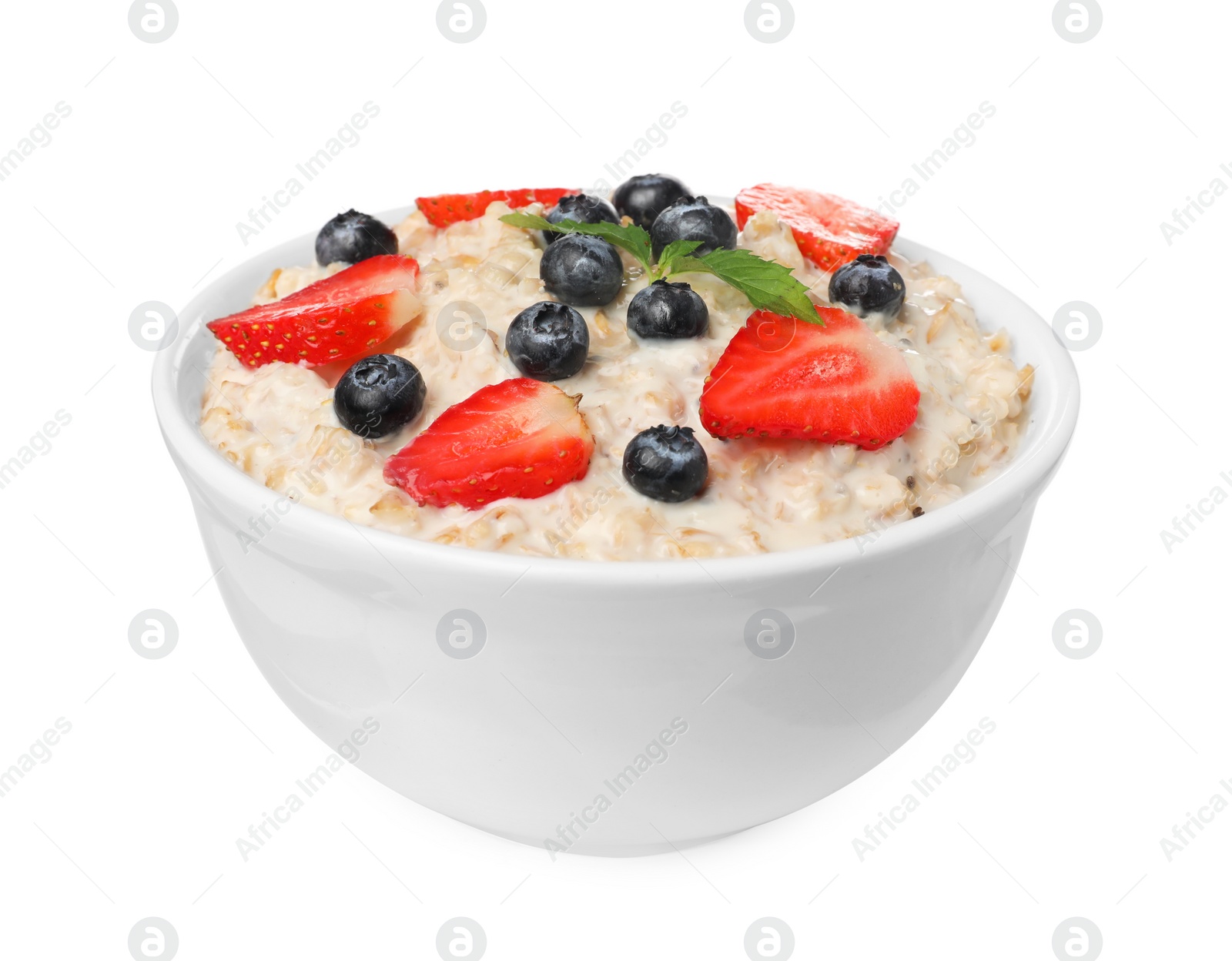 Photo of Tasty boiled oatmeal with berries in bowl isolated on white