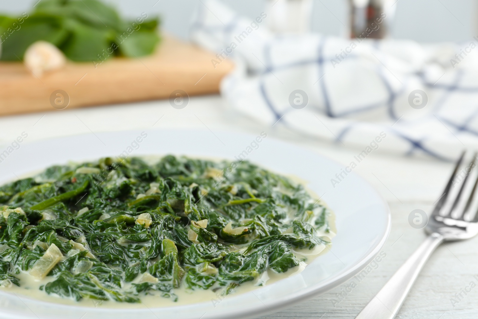 Photo of Tasty spinach dip on white table, closeup