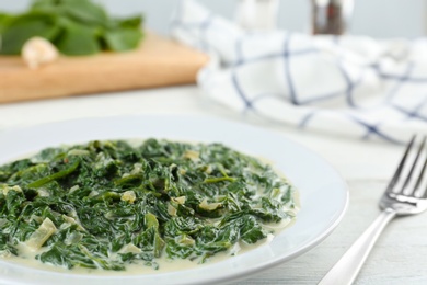 Photo of Tasty spinach dip on white table, closeup