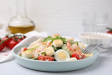 Delicious Caesar salad with shrimps on white table, closeup