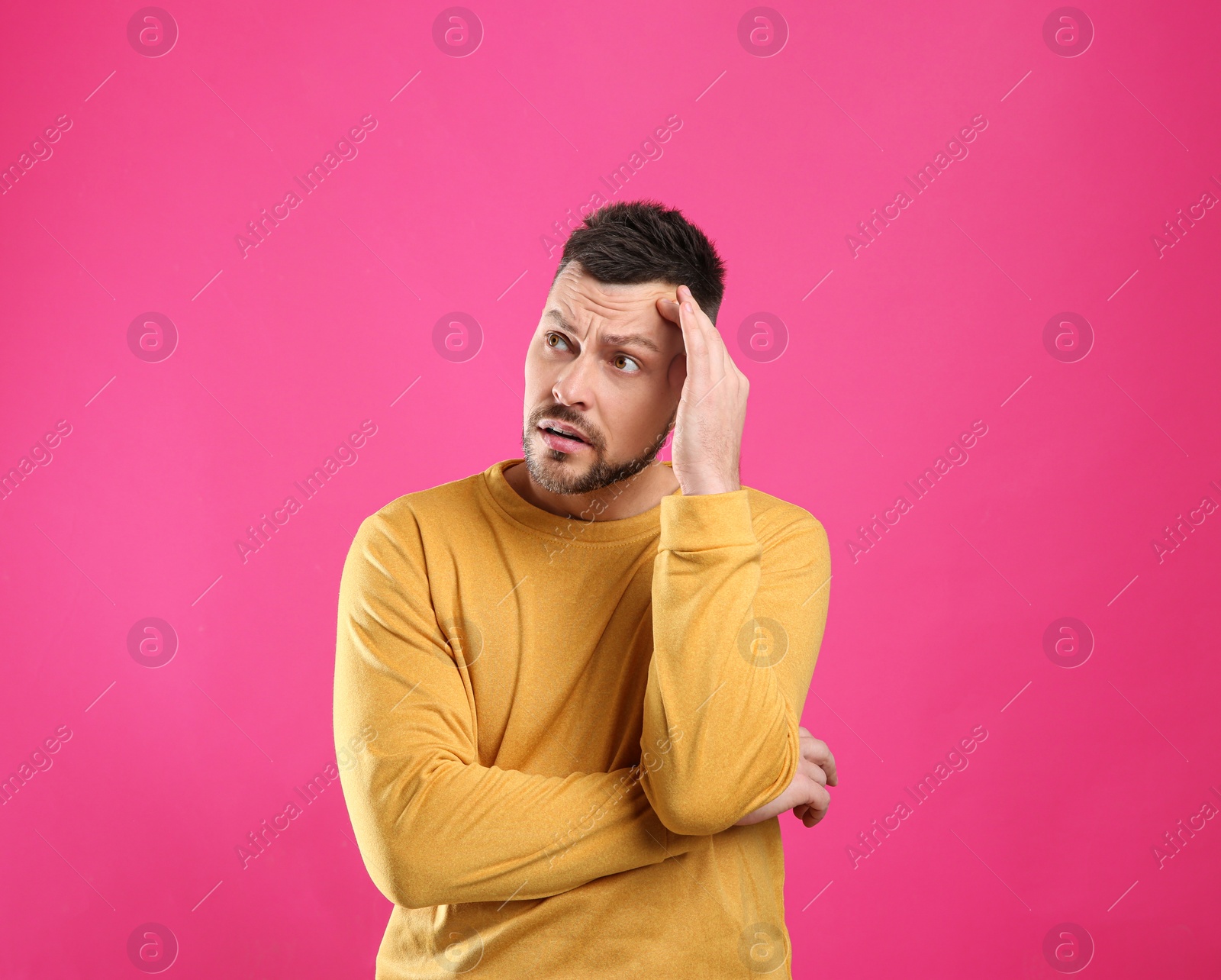 Photo of Emotional man in casual outfit on pink background