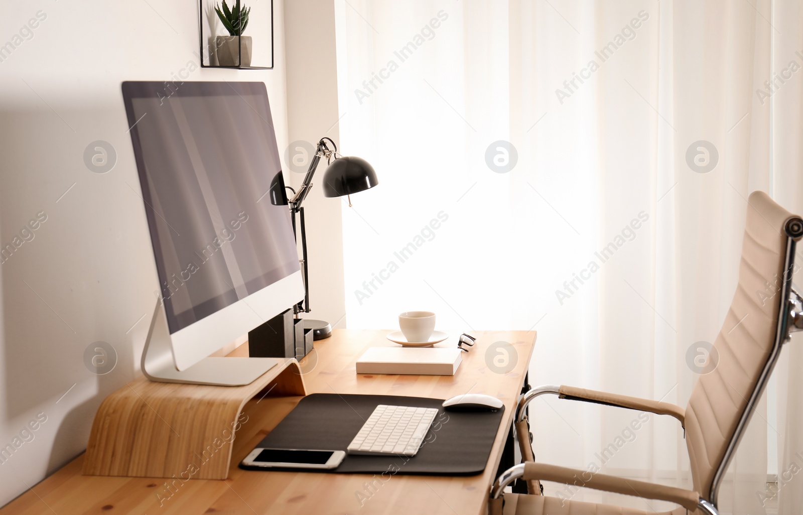 Photo of Stylish workplace interior with modern computer on table. Mockup for design