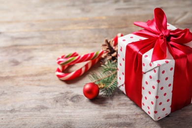 Beautiful composition with gift box and Christmas decorations on wooden table