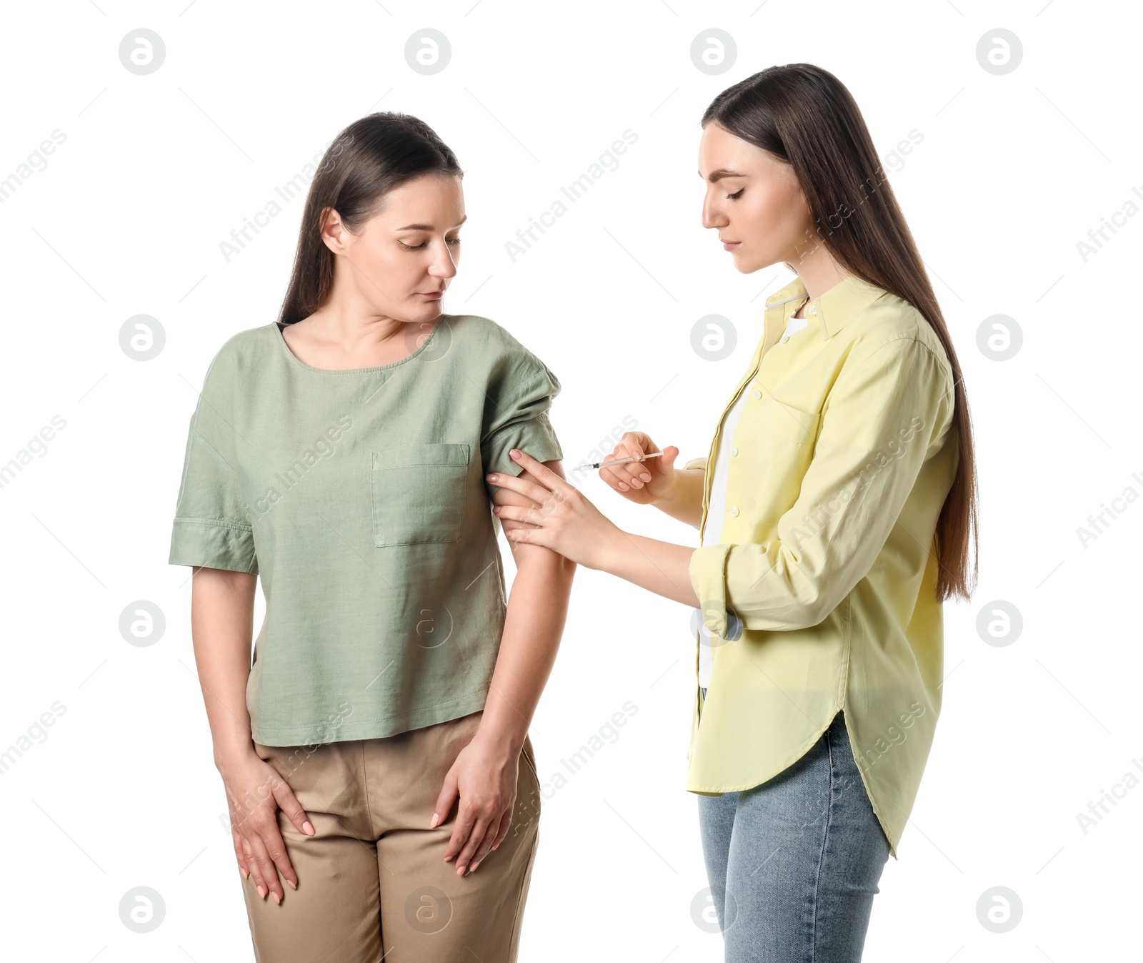 Photo of Woman giving insulin injection to her diabetic friend on white background