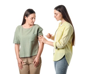 Woman giving insulin injection to her diabetic friend on white background