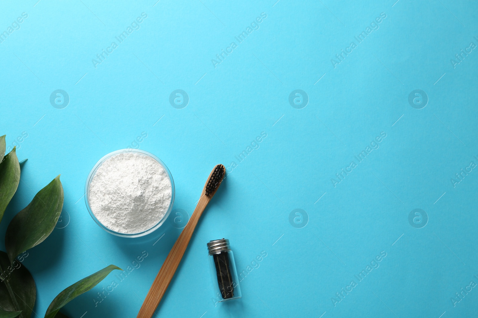 Photo of Bowl of tooth powder, brush, dental floss and plant on turquoise background, flat lay. Space for text