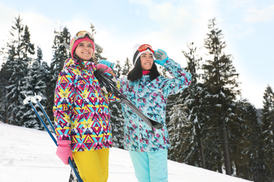 Photo of Young skiers wearing winter sport clothes outdoors