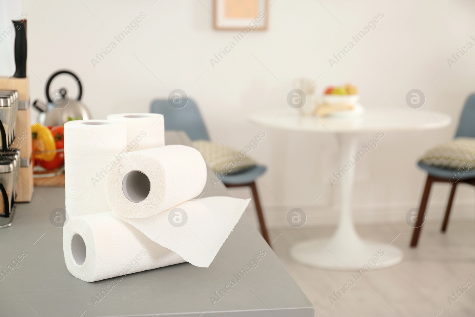 Photo of Rolls of paper towels on table in kitchen