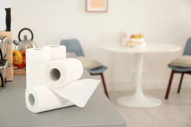 Rolls of paper towels on table in kitchen