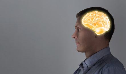 Image of Thinking concept, space for text. Man and illustrated brain on grey background