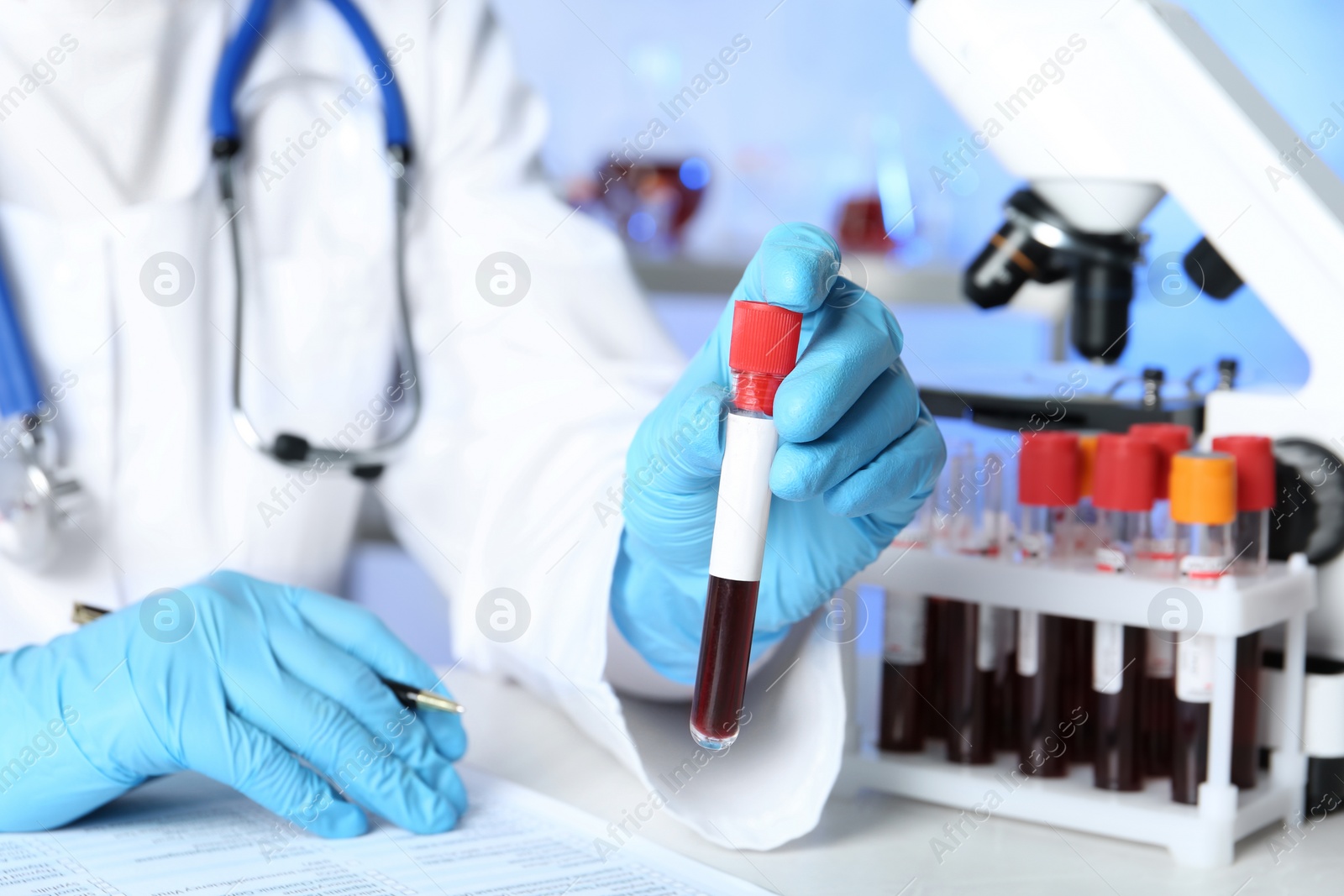 Photo of Scientist working at table in laboratory, closeup. Research and analysis